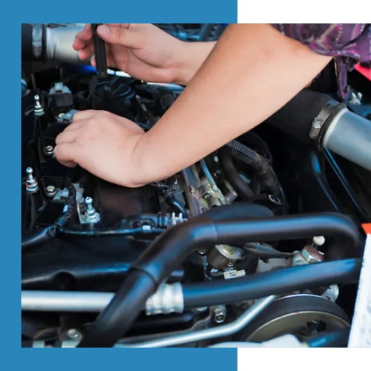 Mechanic servicing a vehicle engine